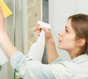 Woman Cleaning Mirror in Salt Lake City
